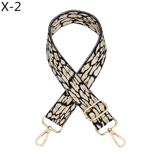 Detailed view of adjustable leopard print bag strap with durable gold metal lobster clasps