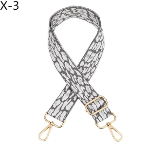 Close-up of leopard print bag strap with adjustable golden metal buckle and swivel hooks