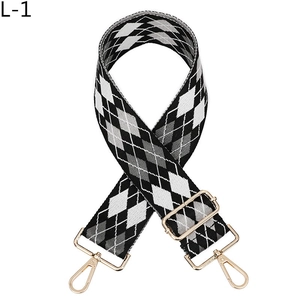 Detail of adjustable argyle jacquard shoulder strap with gold metal hooks for handbags
