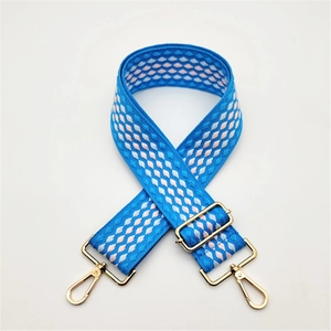 Adjustable sky blue woven bag strap with pink geometric pattern and gold hardware