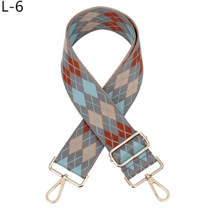 Close-up of jacquard argyle bag strap with gold metal hooks and adjustable buckle