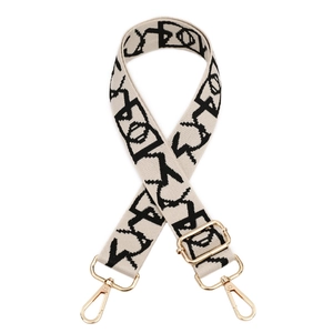 Detail of adjustable off-white bag strap with black patterns and gold metal lobster clasps
