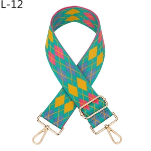 Close-up of adjustable jacquard bag strap with geometric diamond pattern and gold hardware