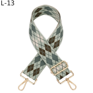 Detail of adjustable argyle woven strap with high-gloss gold metal swivel lobster clasps