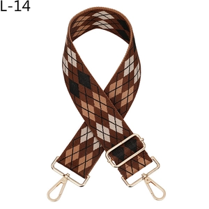 Close-up of jacquard argyle bag strap with golden metal hooks and adjustable fabric weave