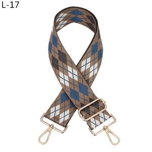 Detailed close-up of adjustable argyle pattern shoulder strap with gold metal hooks