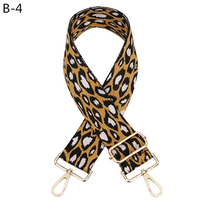 Detail of leopard print wide bag strap with gold metal hooks and adjustable buckle