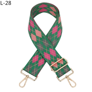 Detail of jacquard argyle bag strap with light gold lobster clasps and metal slide buckle