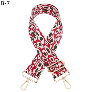 Detail of adjustable leopard print bag strap with golden metal hooks and buckle
