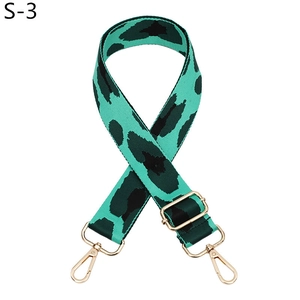 Detail of adjustable turquoise and black leopard print bag strap with gold metal hooks