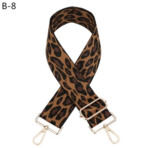 Close-up of adjustable leopard print bag strap with high-quality gold metal hooks
