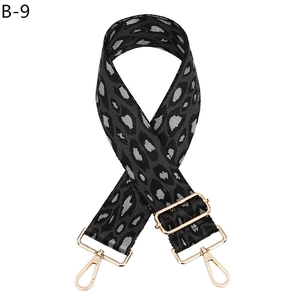 Detail of adjustable leopard print bag strap with golden metal swivel hooks and buckles