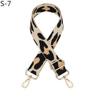 Detailed view of the leopard print woven bag strap with golden lobster clasps