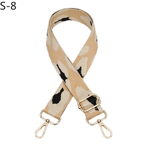 Detail of adjustable leopard print bag strap with durable canvas and gold metal hooks
