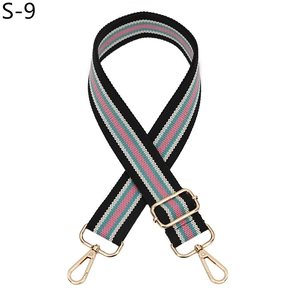 Close-up of colorful striped bag strap with light gold metal lobster clasps and buckles