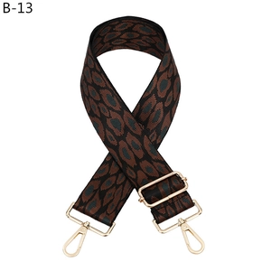 Detail of adjustable leopard print bag strap with golden metal lobster clasps