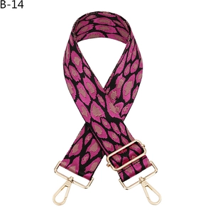 Adjustable leopard print bag strap with pink and black webbing and gold metal hooks