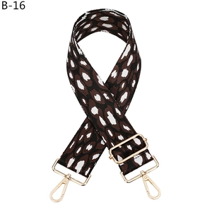 Detail view of adjustable leopard print wide bag strap with gold metal hooks