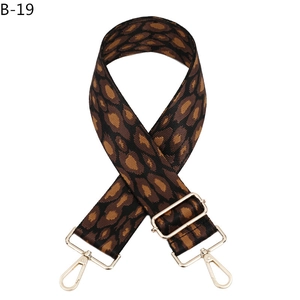 Detail of adjustable leopard print bag strap with polished gold-tone metal swivel hooks