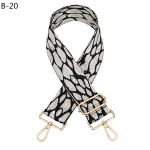 Close-up of leopard print wide bag strap with adjustable golden metal buckle and hooks