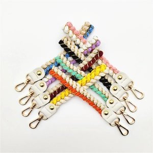 Detailed view of colorful braided wrist straps with gold lobster clasps for handbags
