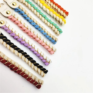 Detailed row of colorful braided rope straps with gold snaps and leather finish