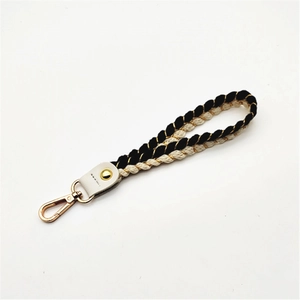 Detail of woven rope wrist strap with gold metallic threads and metal carabiner clasp
