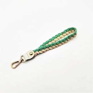 Handmade woven cotton wrist strap with green cream ropes and golden lobster clasp charm