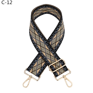Close-up of adjustable geometric rhombus pattern woven strap with gold metal hooks