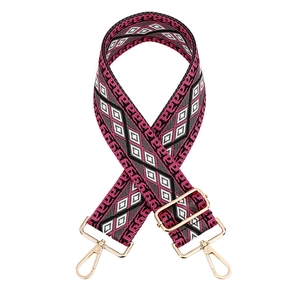 Adjustable crossbody shoulder strap with pink and black diamond pattern and gold hardware