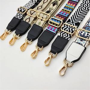 Close-up of ethnic style woven bag straps with PU leather ends and gold metal hooks