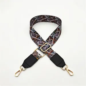 Close-up of ethnic geometric strap with gold swivel hooks and black leather ends