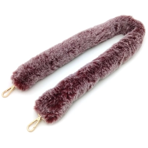 Detail of burgundy faux rabbit fur shoulder strap with gold metal lobster clasps