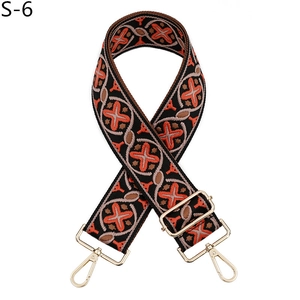 Detail of colorful geometric woven bag strap with golden metal swivel hooks and buckles