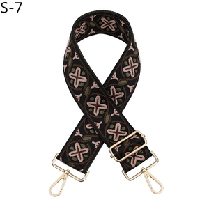 Detail of adjustable bohemian jacquard bag strap with star pattern and gold lobster clasps