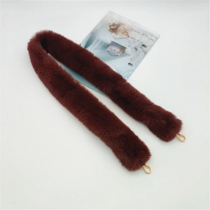 Detail showing plush faux fur shoulder strap in reddish brown with gold lobster clasps