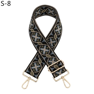 Detail showing ethnic style woven shoulder strap with geometric patterns and gold hardware