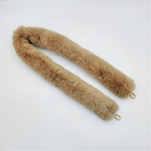 Detail of camel faux fur shoulder strap with gold metal lobster clasps for handbags