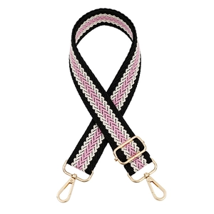 Close-up of adjustable woven shoulder strap in black, white, and pink with gold hooks