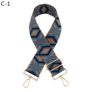 Detail of blue and brown geometric jacquard bag strap with gold rotating metal hooks
