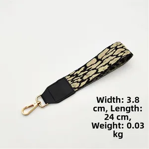 Detail of 3.8cm wide leopard pattern bag strap with gold metal hooks and 24cm length