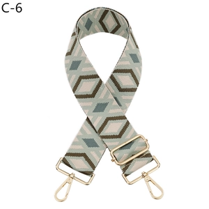 Detail of diamond pattern woven bag strap with golden metal swivel hooks and slide buckle