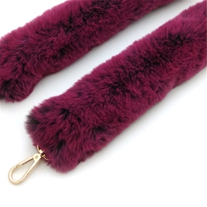 Close-up of purple faux fur handbag strap with gold metallic swivel lobster clasps