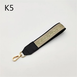 Detail of woven strap with gold glitter stripe and premium metal lobster clasp