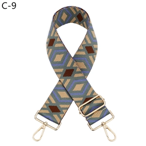 Close-up of geometric diamond pattern shoulder strap with gold-tone metal clasps