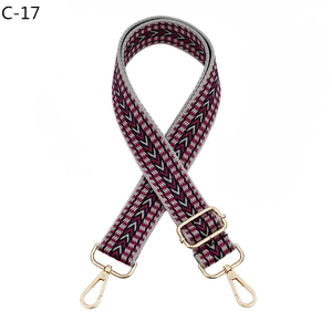 Detailed view of adjustable woven strap with pink geometric patterns and gold metal hooks