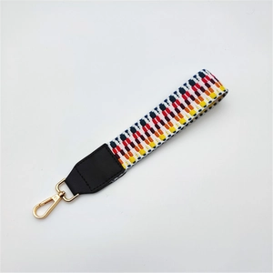 Ethnic style woven wrist strap with colorful geometric patterns and golden metal hooks