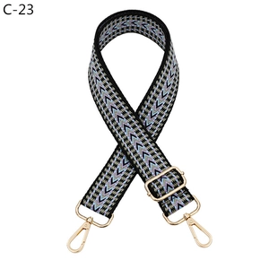 Detail of adjustable wave pattern bag strap with light gold metal lobster clasps