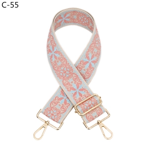 Detail of floral embroidered bag strap with golden lobster clasp and adjustable buckle