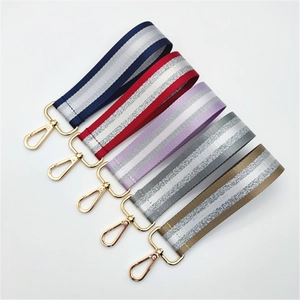 Five assorted striped nylon wrist straps with silver silk weave and gold lobster clasps